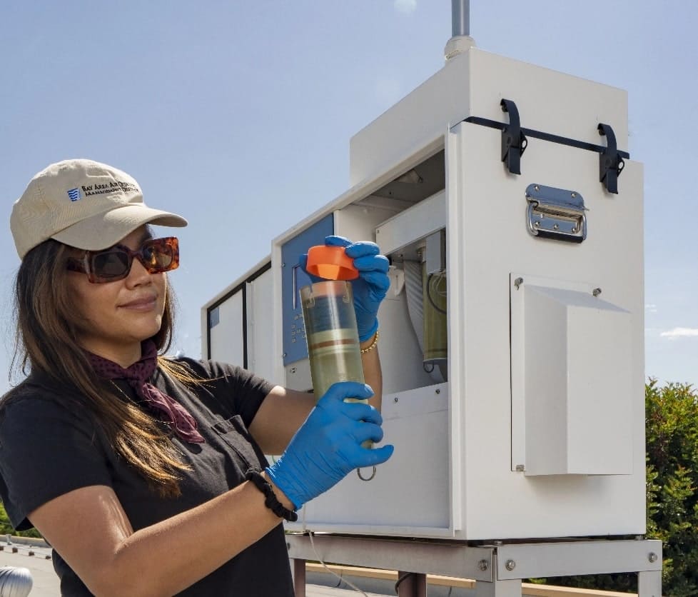 Air Quality Technician servicing air monitoring station