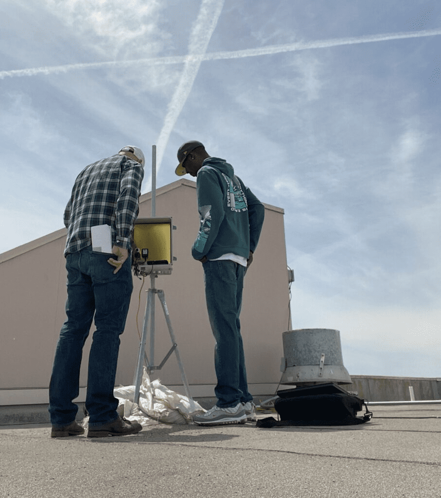 Technicians analyzing machinery for air quality