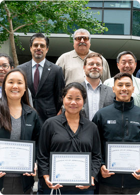 Team photo with people holding certificates